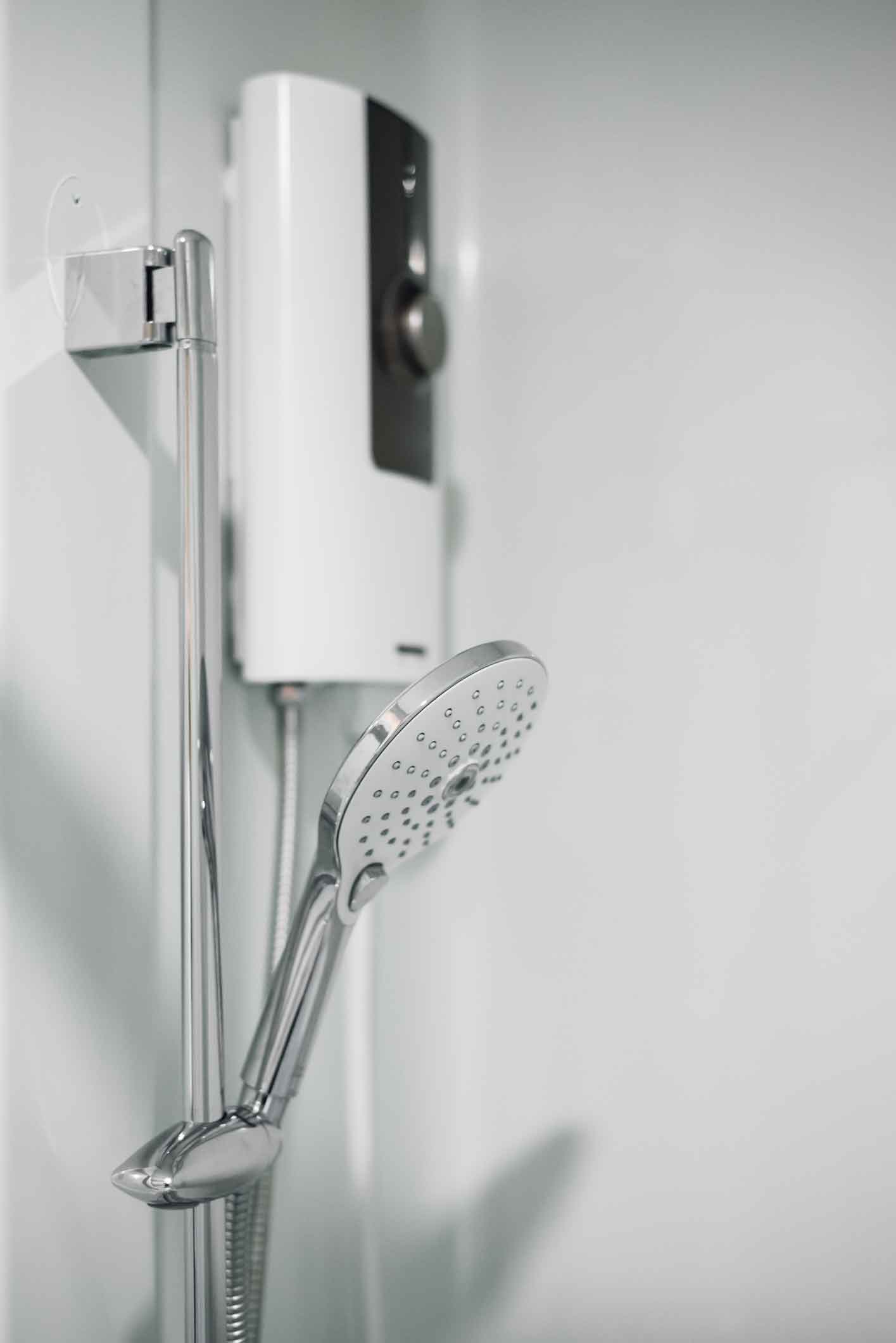 dreamstime_m_226913829 Side view of shower and electric water heater in the bathroom.